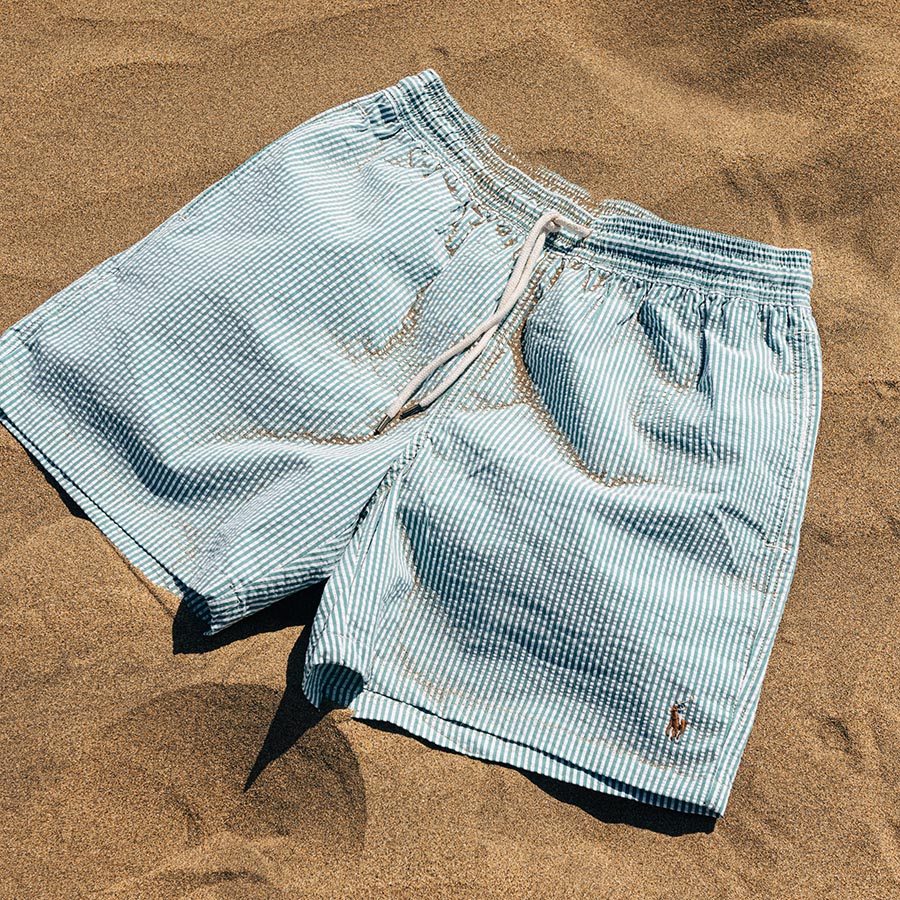 A pair of swimming shorts on a sandy beach