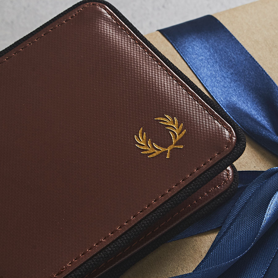 A close up image of a Fred Perry wallet - the ideal designer gift