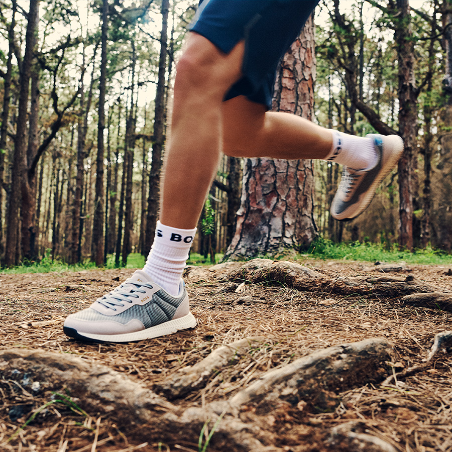A man trail running in designer trainers