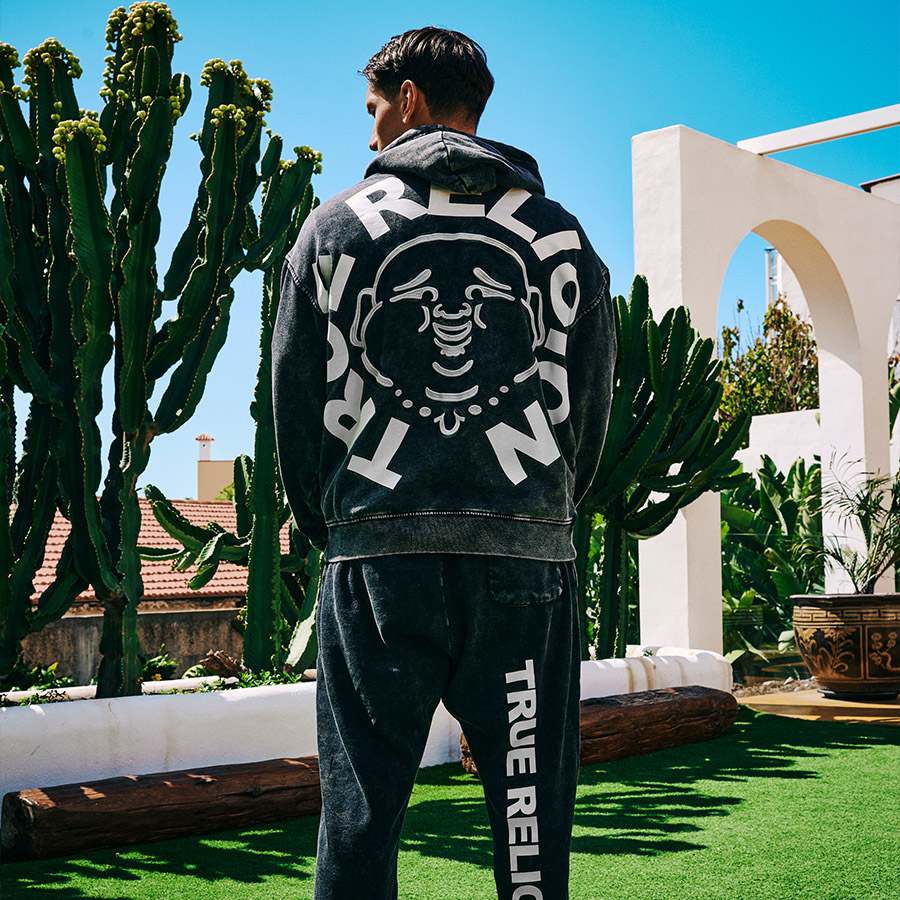 A man facing away from the camera in a True Religion outfit