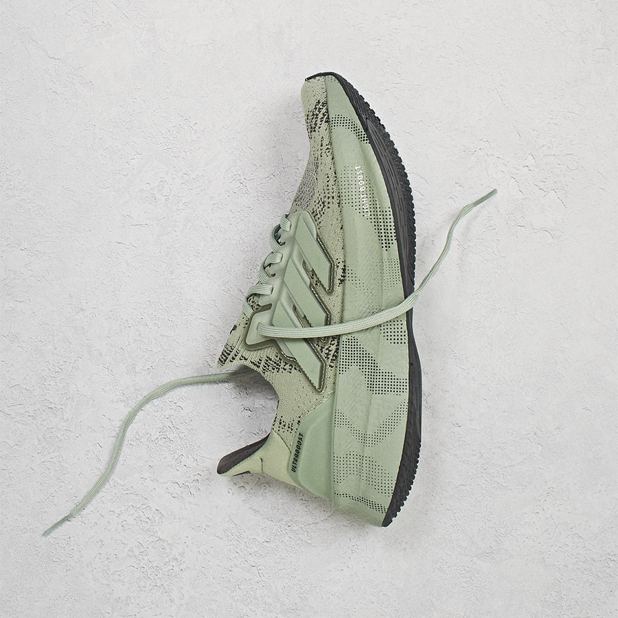 An adidas trainer against a grey background