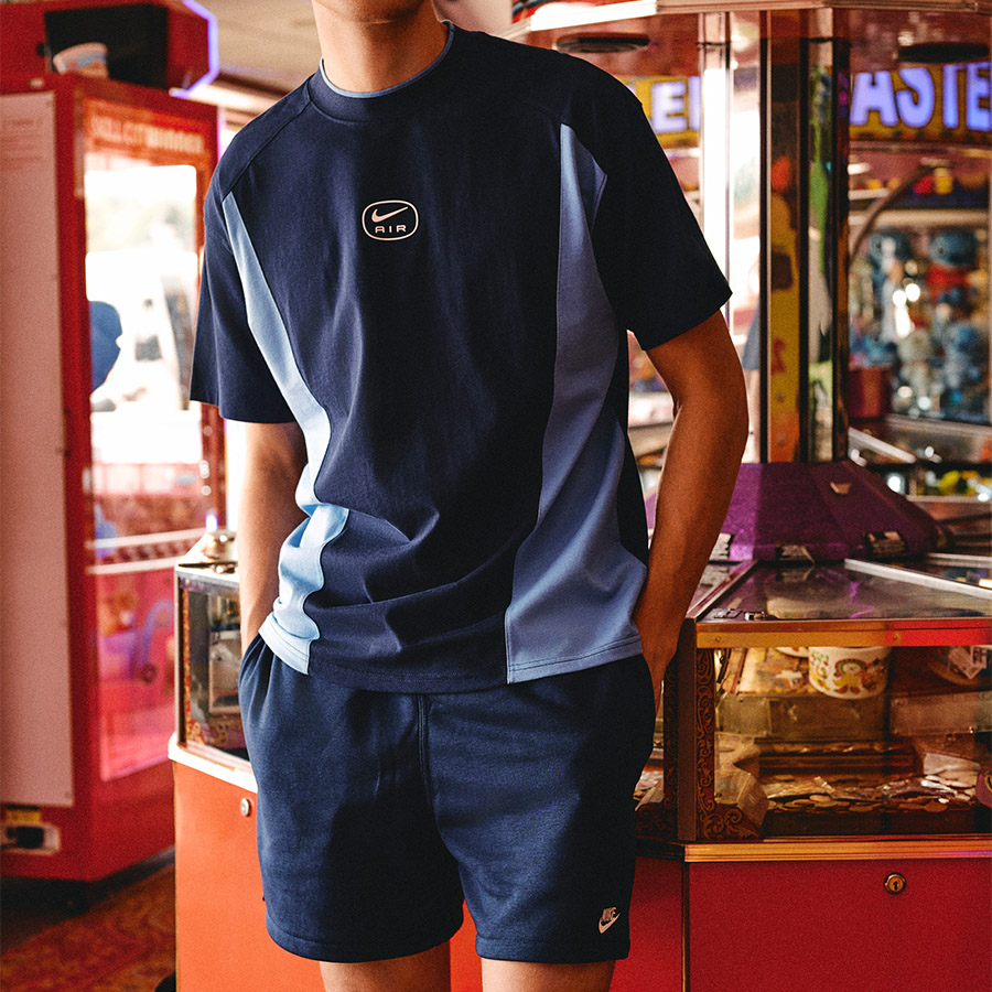 A man wearing sportswear standing in an arcade