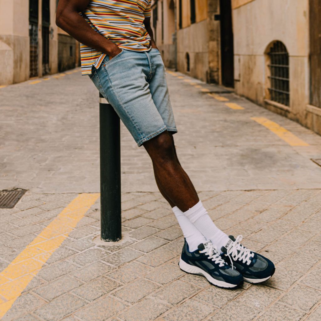 A guy in denim shorts leaning